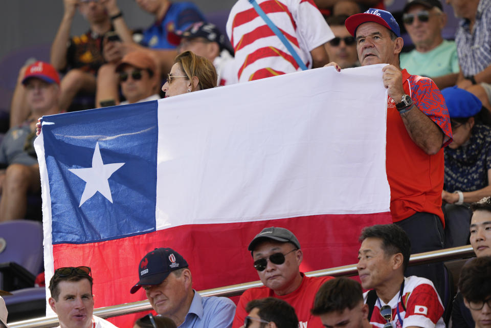 A Chilean supporter holds up a flag ahead of the Rugby World Cup Pool D match between Japan and Chile at Stadium de Toulouse, Toulouse, France, Sunday, Sept. 10, 2023. (AP Photo/Lewis Joly)