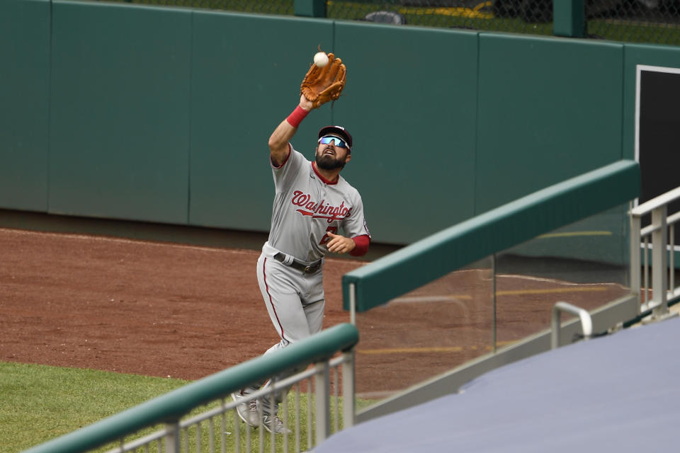 Washington Nationals right fielder Adam Eaton makes a catch on a fly ball by Toronto Blue Jays' Bo Bichette during the third inning of a baseball game Thursday, July 30, 2020, in Washington. (AP Photo/Nick Wass)