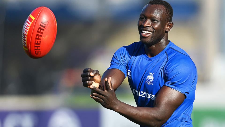 Majak Daw is pictured handballing during a North Melbourne training session.