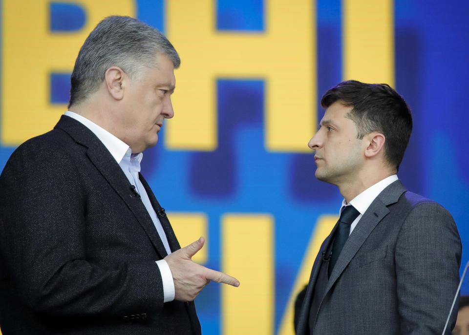 Ukrainian presidential candidate and popular comedian Volodymyr Zelenskiy listens to Ukrainian President Petro Poroshenko during their final electoral campaign debate at the Olympic stadium in Kiev, Ukraine, Friday, April 19, 2019. Friday is the last official day of election canvassing in Ukraine as all presidential candidates and their campaigns will be barred from campaigning on Saturday, the day before the vote. (AP Photo/Vadim Ghirda)