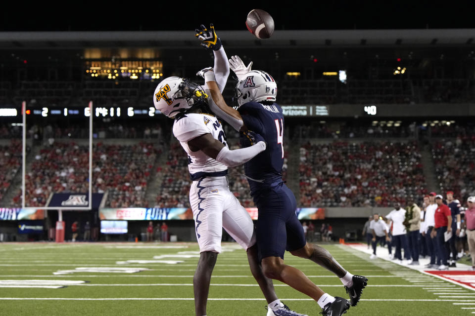 Northern Arizona defensive back Colby Humphrey knocks the ball away from Arizona wide receiver Tetairoa McMillan (4) during the first half of an NCAA college football game Saturday, Sept. 2, 2023, in Tucson, Ariz. (AP Photo/Rick Scuteri)