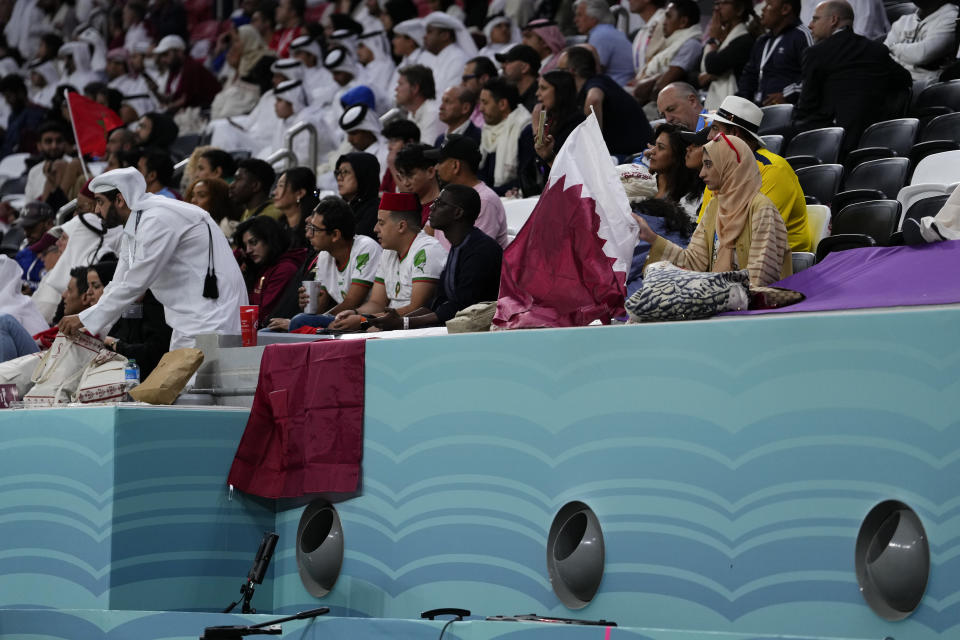 Fans sit on the stands above air conditioning ventilators during a World Cup group A soccer match between Qatar and Ecuador at the Al Bayt Stadium in Al Khor , Qatar, Sunday, Nov. 20, 2022. (AP Photo/Manu Fernandez)