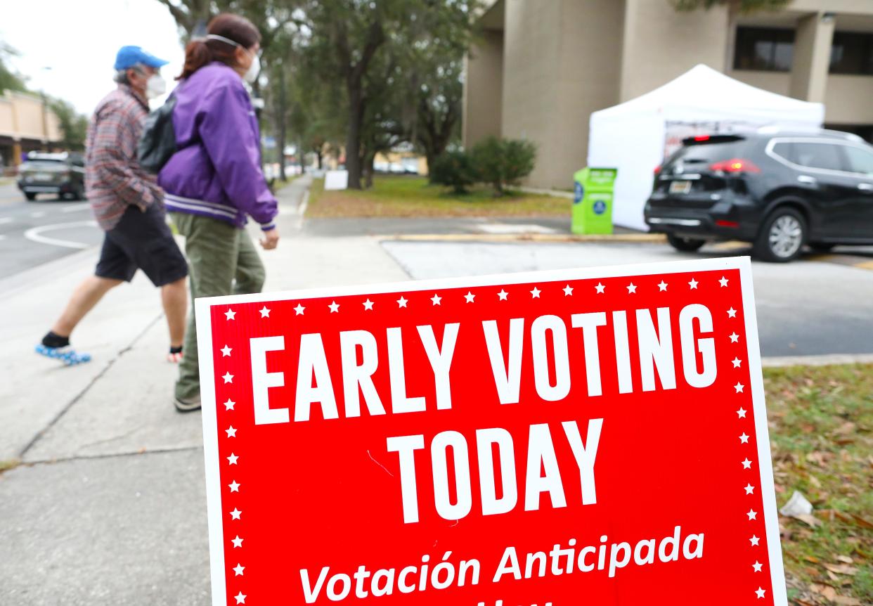 Alachua County voters walk past a sign as they go to vote at the Alachua County Supervisor of Elections Office earlier this year. The deadline is Aug. 13 to request mail-in-ballots for the Aug. 23 primary election and early voting for that election will be held from  [Brad McClenny/The Gainesville Sun]