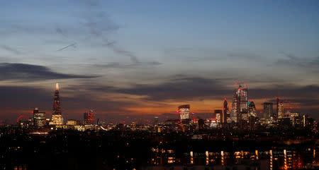 FILE PHOTO: The sun sets behind the financial district of London, Britain, February 13, 2019. REUTERS/Phil Noble/File Photo