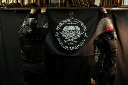 Members of the Union of Orthodox Banner-Bearers prepare for an informal award ceremony at their headquarter in Moscow, Russia, December 24, 2017. The Union of Orthodox Banner Bearers is a small fringe group of Russian nationalists with no political power that is convinced Russia should be ruled by an autocratic monarch. REUTERS/Ekaterina Anchevskaya