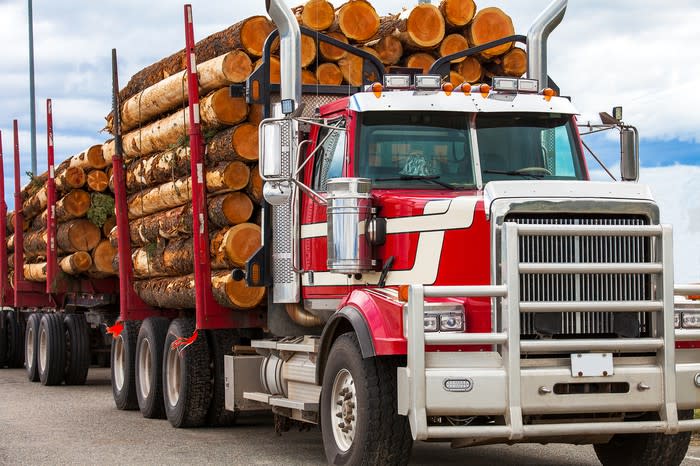 Truck hauling logs from a job site.
