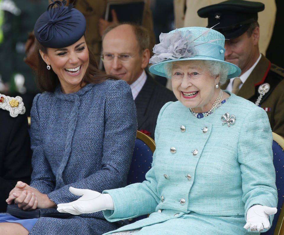 Britain's Catherine, Duchess of Cambridge (L) laughs as Queen Elizabeth gestures while they watch part of a children's sports event during a visit to Vernon Park in Nottingham, central England, June 13, 2012. REUTERS/Phil Noble (BRITAIN - Tags: ENTERTAINMENT SOCIETY ROYALS)