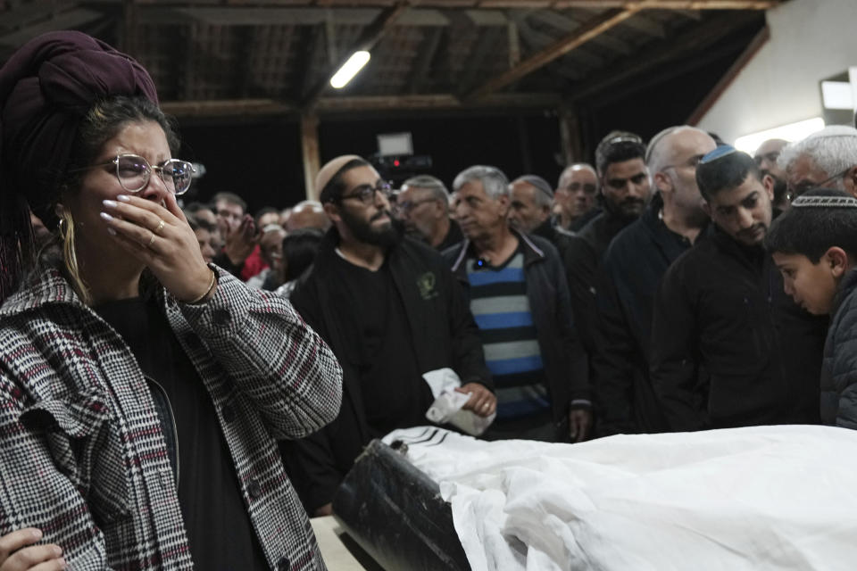 A relative weeps at the funeral for Tamir Avihai, 50, in the West Bank Israeli settlement of Barkan, Tuesday, Nov. 15, 2022. A Palestinian killed three Israelis, including Avihai and wounded three others in an attack in a settlement in the occupied West Bank on Tuesday before he was shot and killed by Israeli security personnel, Israeli paramedics and Palestinian officials said. (AP Photo/ Tsafrir Abayov)