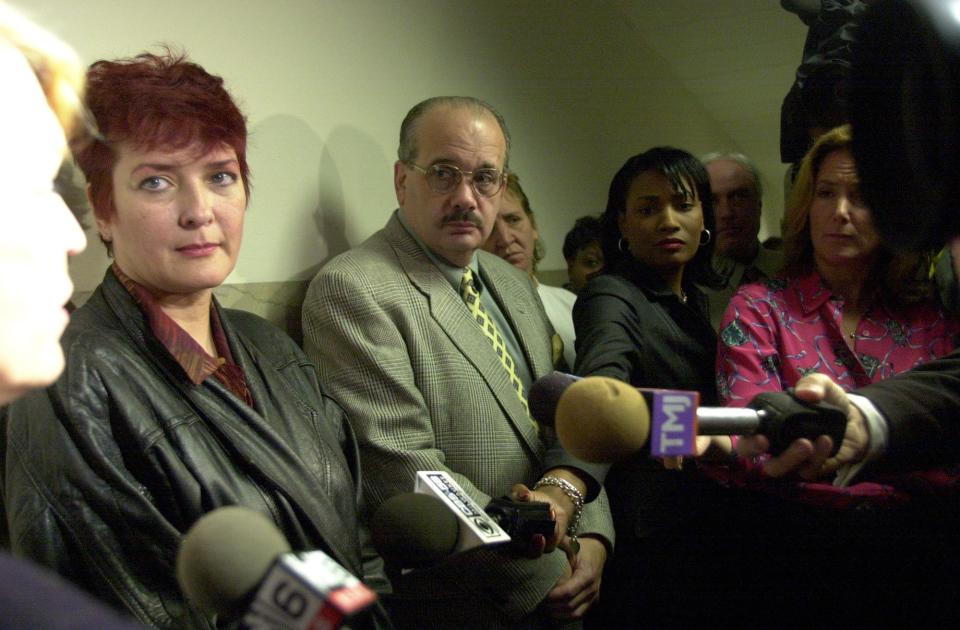 Flanked by attorney Mary L. Woehrer and investigator Ira Robins, Lawrencia Bembenek holds an impromptu news conference after appearing in a Milwaukee court Oct. 4, 2002 to present a motion for DNA testing of evidence presented in her 1982 trial, where she was convicted of murdering her ex-husband's first wife.