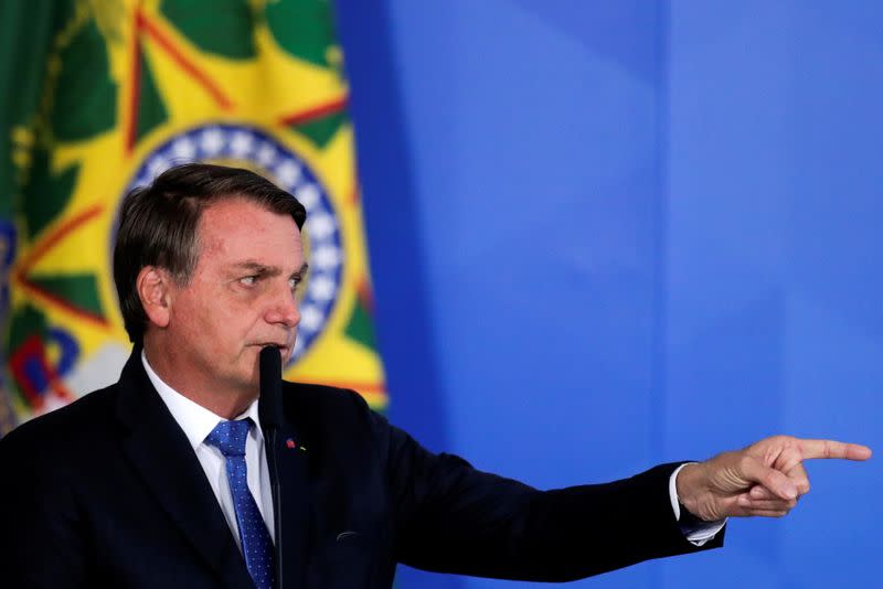 Brazil's President Jair Bolsonaro gestures during the launching ceremony of the Voo Simples program, at the Planalto Palace in Brasilia