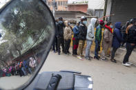 People stand in a queue to receive the vaccine after the Nepalese government made vaccination cards mandatory for people to access public services in Kathmandu, Nepal, Thursday, Jan. 20, 2022. (AP Photo/Niranjan Shrestha)