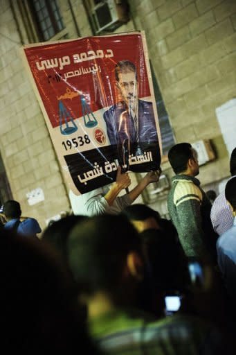 Thousands of supporters of Egyptian President Mohamed Morsi celebrate in front of the Egyptian high court in Cairo. Morsi assumed sweeping powers on Thursday, drawing criticism he was seeking to be a "new pharoah" and raising questions about the gains of last year's uprising to oust Hosni Mubarak