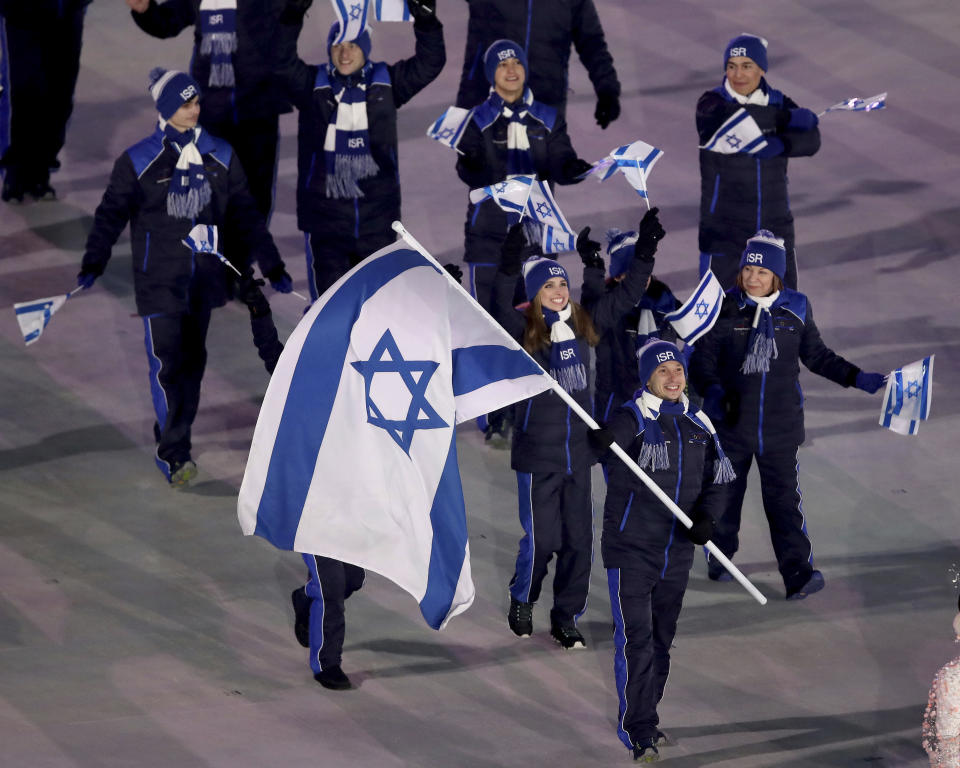 <p>Alexei Bychenko carries the flag of Israel during the opening ceremony of the 2018 Winter Olympics in Pyeongchang, South Korea, Friday, Feb. 9, 2018. (Sean Haffey/Pool Photo via AP) </p>