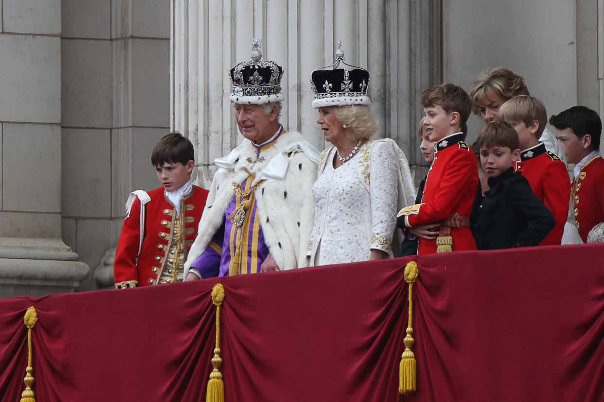 LONDON, ENGLAND - MAY 06: Britain's King Charles III wearing the Imperial state Crown, and Britain's Queen Camilla wearing a modified version of Queen Mary's Crown look on from the Buckingham Palace balcony while viewing the Royal Air Force fly-past the coronation on May 06, 2023 in London, England. The Coronation of Charles III and his wife, Camilla, as King and Queen of the United Kingdom of Great Britain and Northern Ireland, and the other Commonwealth realms takes place at Westminster Abbey today. Charles acceded to the throne on 8 September 2022, upon the death of his mother, Elizabeth II. (Photo by Adrian Dennis - WPA Pool/Getty Images)