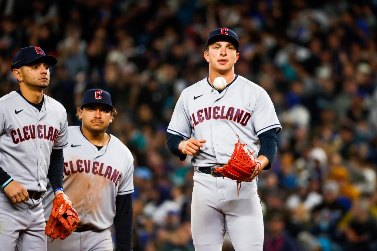 Mar 30, 2023; Seattle, Washington, USA; Cleveland Guardians relief pitcher James Karinchak (99, right) waits to be pulled from the game after surrendering a three-run home run against the Seattle Mariners during the eighth inning at T-Mobile Park. Cleveland Guardians second baseman Andres Gimenez (0, left) and first baseman Josh Naylor join Karinchak on the mound. (Mandatory Credit: Joe Nicholson-USA TODAY Sports