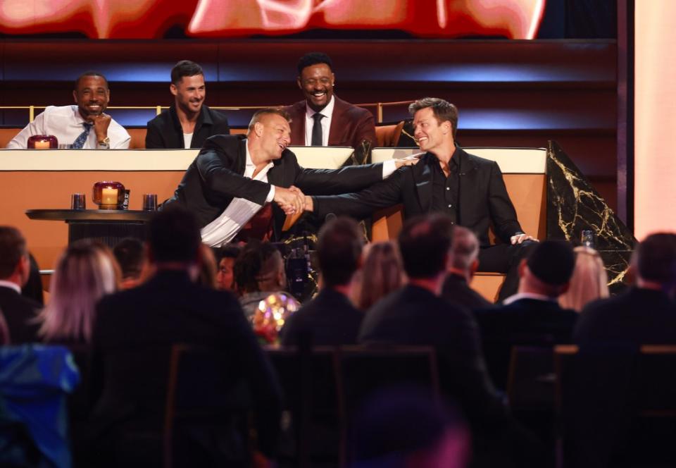 Tom Brady shakes hands with his old teammate Rob Gronkowski during the Netflix roast. Both of them took a lot of hits throughout the night. Getty Images for Netflix