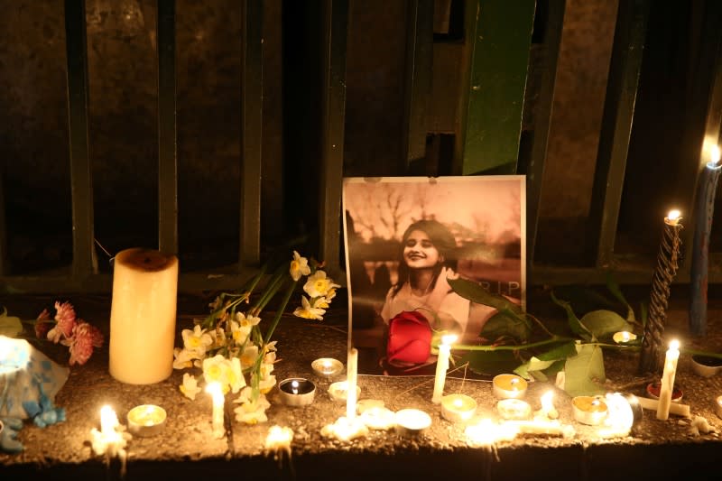 A picture is seen next to candles lit by people and families of the victims of the crash of the Boeing 737-800 plane, flight PS 752, in Tehran