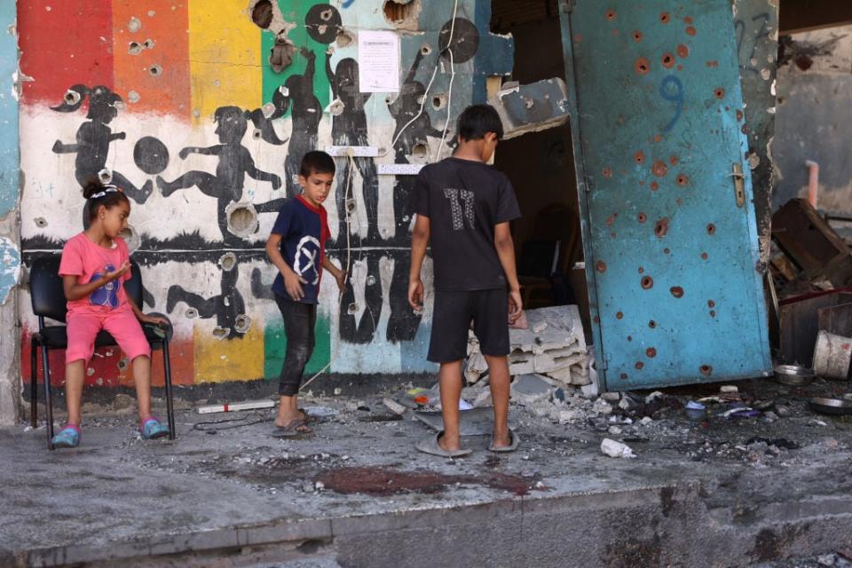 Displaced Palestinian children inspect the damage at the site of an Israeli strike on a school housing displaced Palestinians in Gaza City's Zaytoun neighbourhood on September 21, 2024. Gaza's civil defence agency said an Israeli strike on a school-turned-shelter in the Palestinian territory's largest city killed 19 people, while Israel's military said it targeted Hamas militants. (Photo by Omar AL-QATTAA / AFP) (Photo by OMAR AL-QATTAA/AFP via Getty Images)