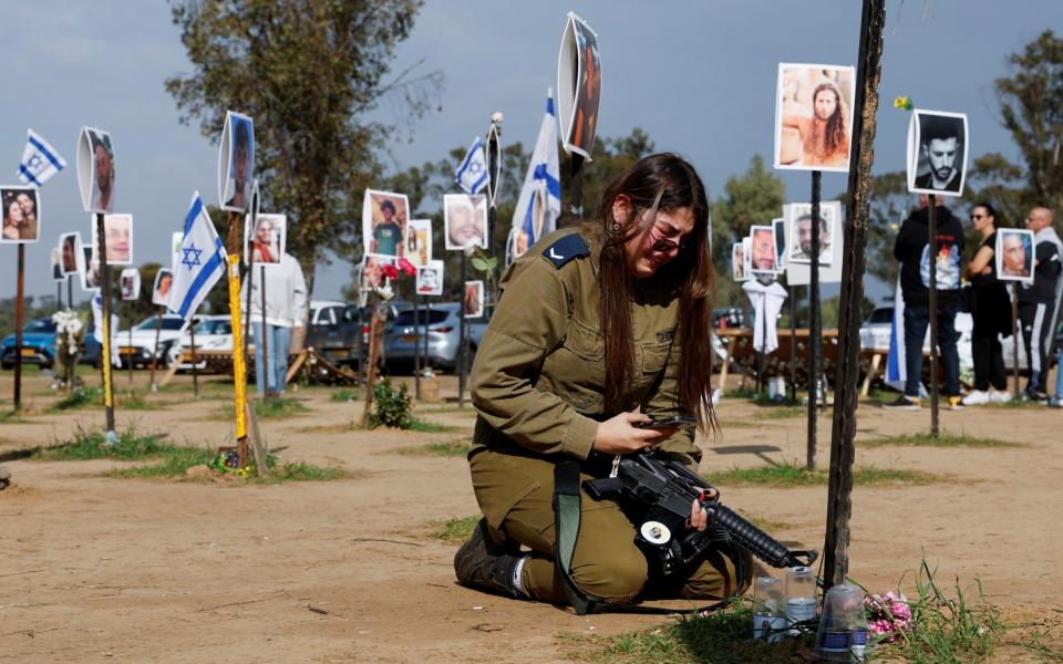 A woman reacts at the site of the Nova festival, where people were killed and kidnapped during the October 7 attack