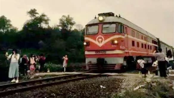 The woman was photographed posing dangerously close to the moving train. Photo: YouTube