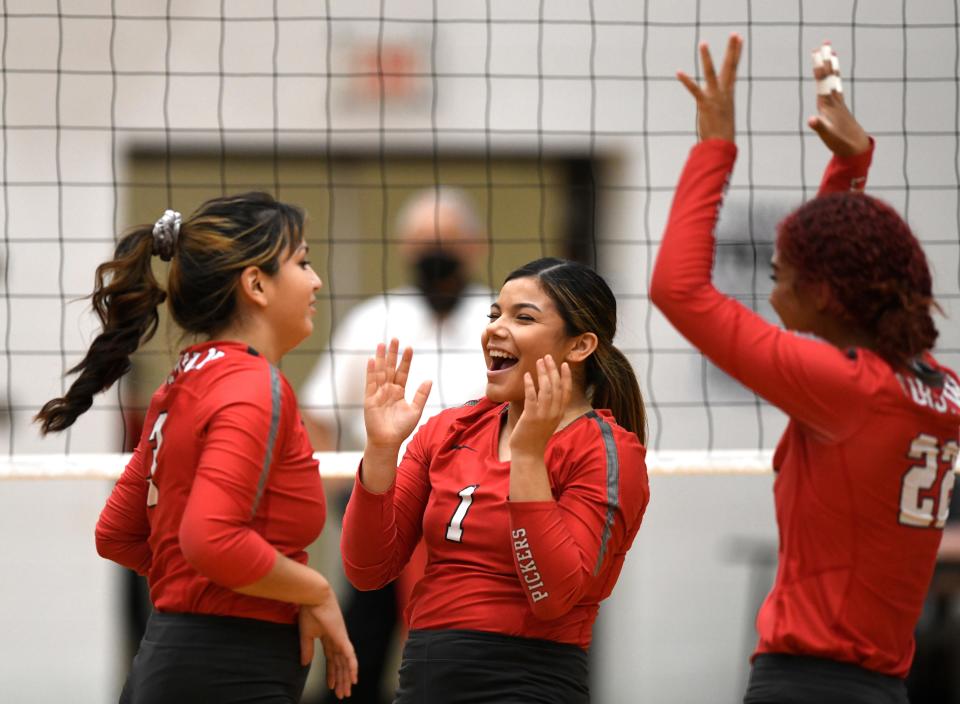 Robstown volleyball players celebrate during a match in 2020 against Calallen. The Cotton Pickers advanced to regional quarterfinals for the first time this season.