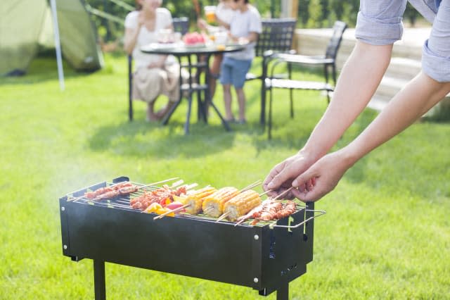 Young family barbecuing outdoors