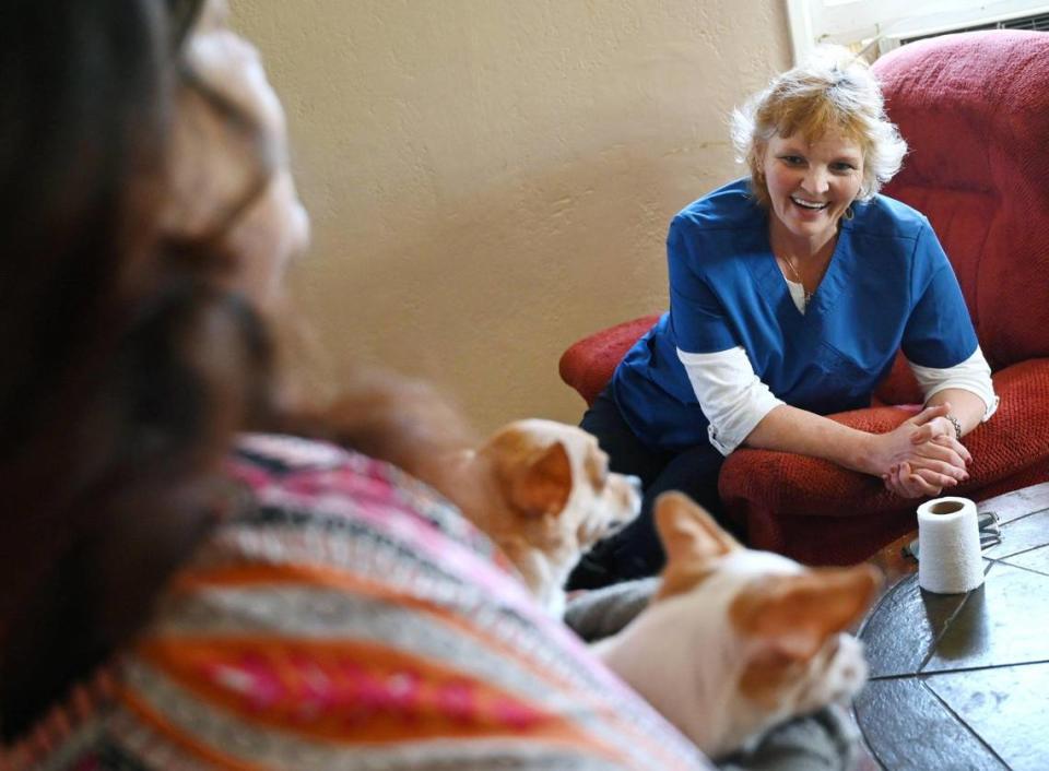 In-Home Support Services (IHSS) care worker Wendy Davenport, laughs as she shares caring for her client Jovonna Martinez, left, Wednesday, March 15, 2023 in Fresno. Davenport and other SEIU workers are looking for a salary increase to $20.