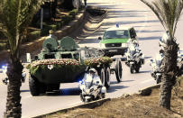 The convoy carrying the coffin of former Algerian President Abdelaziz Bouteflika drives on its way to the El Alia cemetery in Algiers, Sunday, Sept.19, 202. Algeria's leader declared a three-day period of mourning starting Saturday for former President Abdelaziz Bouteflika, whose 20-year-long rule, riddled with corruption, ended in disgrace as he was pushed from power amid huge street protests when he decided to seek a new term. Bouteflika, who had been ailing since a stroke in 2013, died Friday at 84. (AP Photo/Fateh Guidoum)