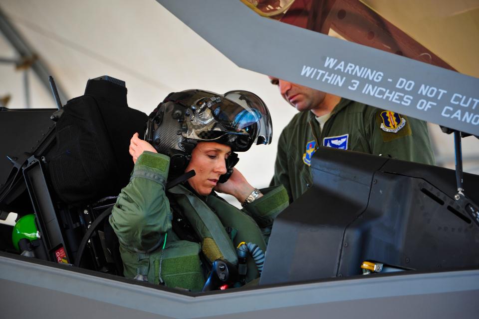 Lt. Col. Christine Mau, 33rd Operations Group deputy commander, puts on her helmet before taking her first flight in the F-35A on Eglin Air Force Base, Fla., May 5. Mau, who previously flew F-15E Strike Eagles, made history as the first female F-35 pilot in the program.