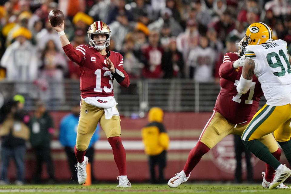 San Francisco 49ers quarterback Brock Purdy (13) throws a pass against the Green Bay Packers during the fourth quarter in a 2024 NFC divisional round game at Levi's Stadium.