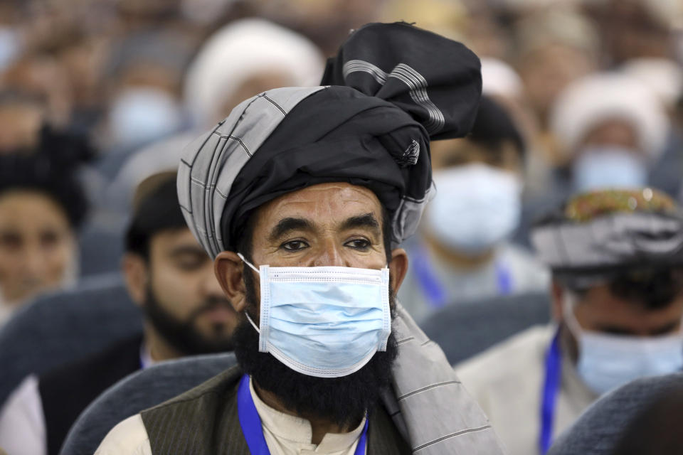 Delegates wearing a protective face masks to help curb the spread of the coronavirus attend an Afghan Loya Jirga meeting in Kabul, Afghanistan, Friday, Aug. 7, 2020. The traditional council opened Friday in the Afghan capital to decide the release of a final 400 Taliban - the last hurdle to the start of negotiations between Kabul’s political leadership and the Taliban in keeping with a peace deal the United States signed with the insurgent movement in February. (AP Photo/Rahmat Gul)