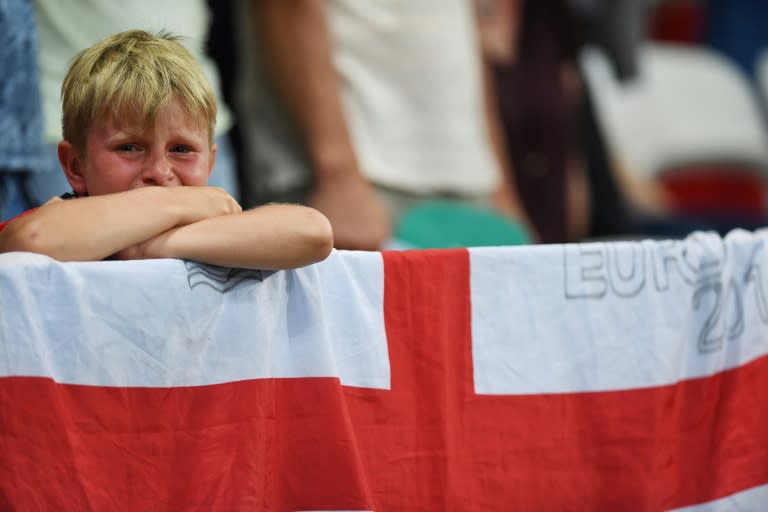 A young England fan in Nice reacts after England lost 1-2 to Iceland in the Euro 2016 match on June 27, 2016