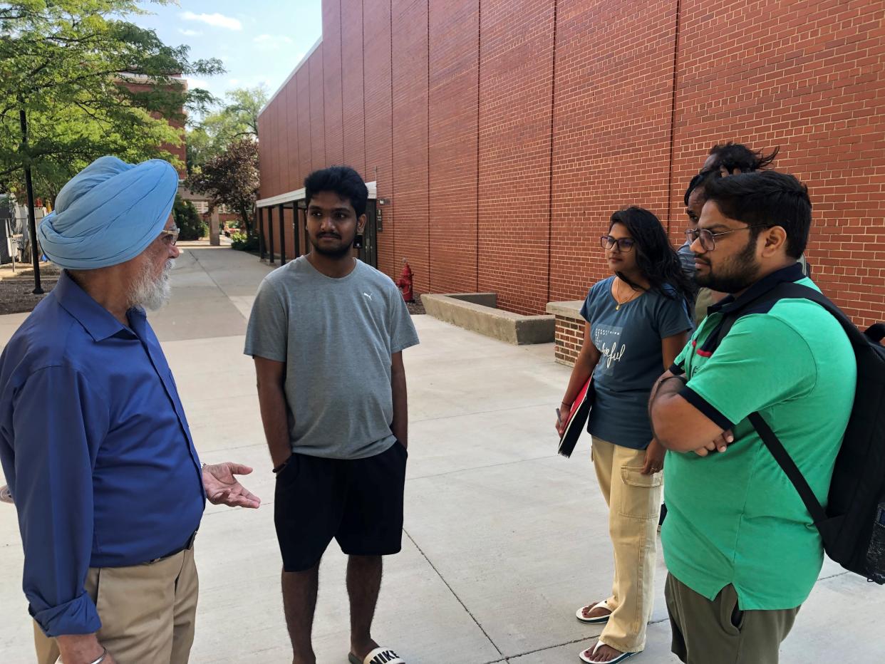 Retired economics professor Swarnjit Arora, left, speaks to newly arrived graduate students from India Aug. 28 at the University of Wisconsin-Milwaukee campus. Arora, who retired in 2018, has continued to serve as an adviser to the Students of India Association.