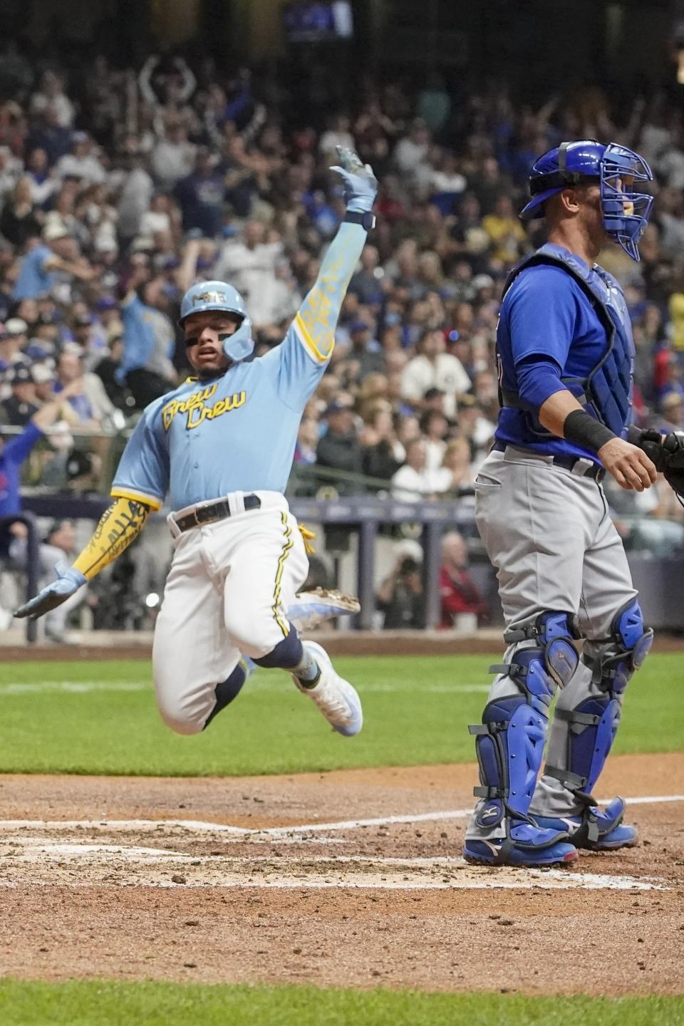 Milwaukee Brewers' William Contreras scopre ppast Chicago Cubs' Yan Gomes during the fifth inning of a baseball game Friday, Sept. 29, 2023, in Milwaukee. Contreras scored on a triple by Carlos Santana. (AP Photo/Morry Gash)