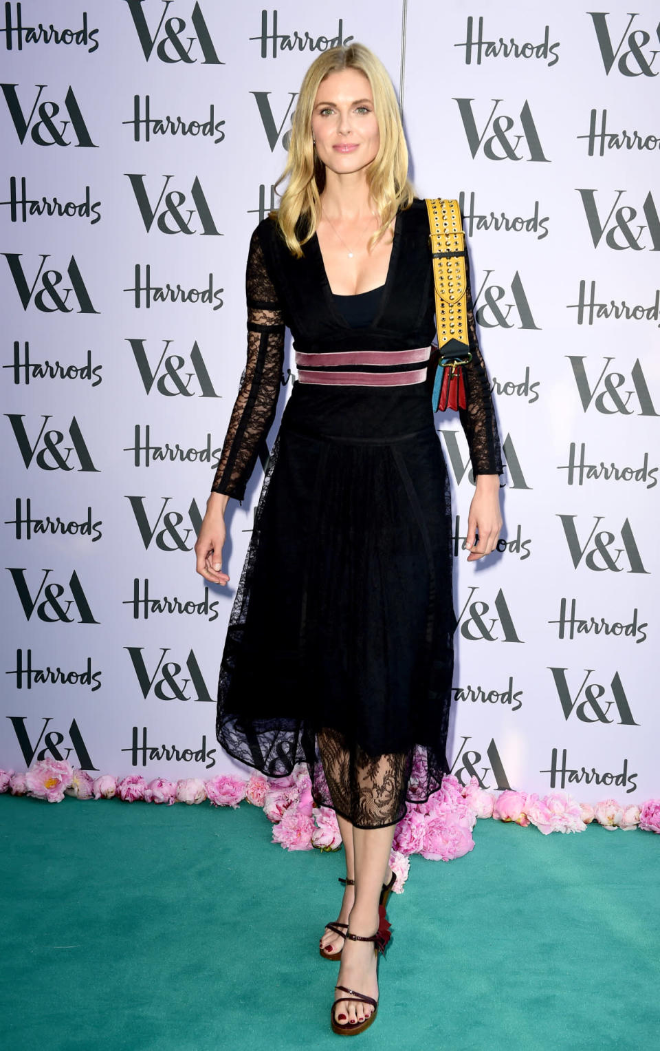 <p>Wearing a black midi dress, with a sheer hemline and sleeves.<i> [Photo: PA Images]</i></p>