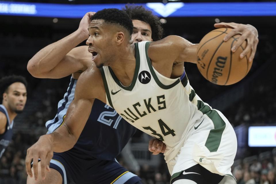 Milwaukee Bucks' Giannis Antetokounmpo drives past Memphis Grizzlies' Desmond Bane during the first half of a preseason NBA basketball game Friday, Oct. 20, 2023, in Milwaukee. (AP Photo/Morry Gash)