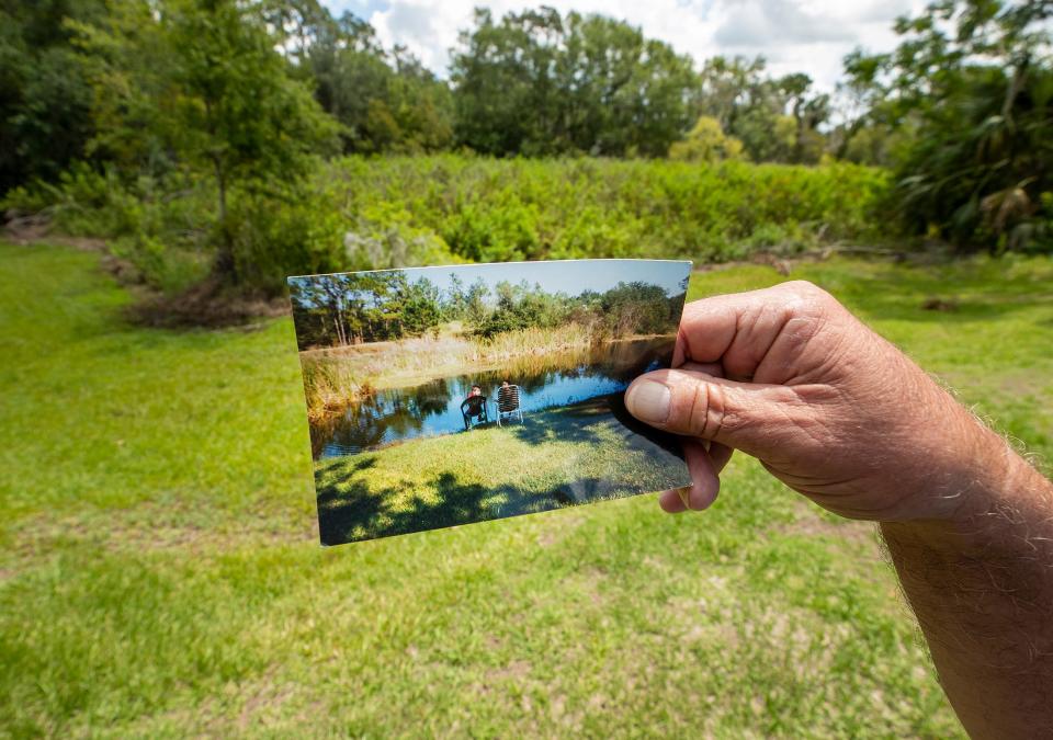 Imperial Lakes resident David Kolodziej holds a photo of what the retention pond looked like behind his home.