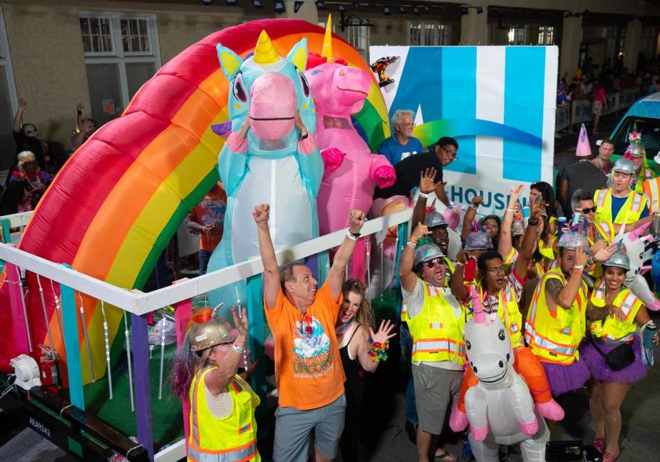 A large-scale unicorn duo presides over a crew of costumed “construction workers” during the Fantasy Fest Parade Saturday, Oct. 28, 2023, in Key West.