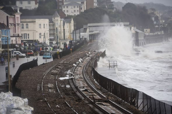 Composite image with file photos dated 05/02/14 (top) and image dated 12/03/14 (bottom) showing a before and after of the damage and subsequent repairs to the sea wall and railway line at Dawlish in Devon, as the storm-wrecked railway line is due to reopen as planned at the end of this week, Network Rail (NR) has confirmed. PRESS ASSOCIATION Photo. Issue date: Monday March 31, 2014. The coast-hugging stretch of line was first severely damaged in this winter's savage storms and damaged again in another violent storm on February 14. With the line shut and round-the-clock work going on to bring it back into service, a  massive landslip, involving the collapse of 20,000 tonnes of cliff-face near Teignmouth on March 4, had threatened the planned re-opening. But NR said today the reopening - on Friday - was going ahead. NR chief executive Mark Carne said: 