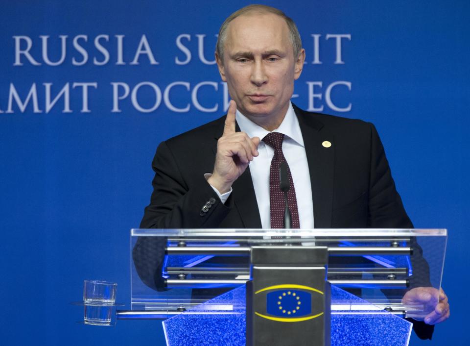 Russian President Vladimir Putin gestures while speaking during a news conference at the European Commission headquarters in Brussels, Belgium, Tuesday, Jan. 28, 2014. Russian President Vladimir Putin and European Union leaders are looking for meager common ground during what promises to be a difficult summit centering on Ukraine and human rights. (AP Photo/Alexander Zemlianichenko)