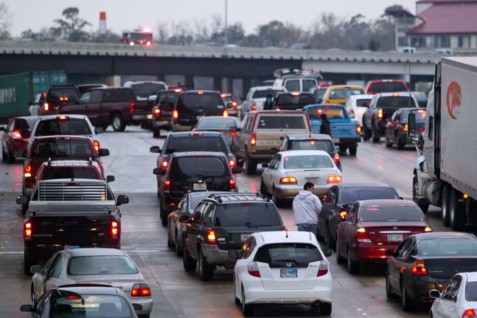 <p>Smiley N. Pool/Houston Chronicle via Getty</p> Motorist exit their cars as traffic comes to a stop on westbound 1-10 at I-45 due to icy conditions on Friday, Feb. 4, 2011, in Houston.