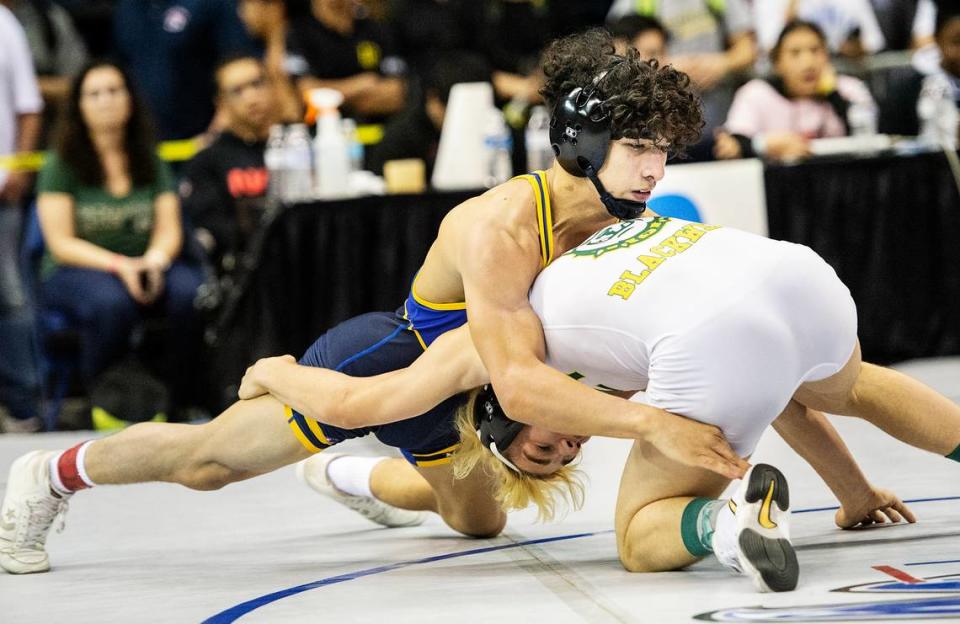 Adrian Heras of Turlock wrestles Eli Blackwell of Tracy at 132-pounds during the 2020 CIF Sac-Joaquin Section Masters Meet at Stockton Arena in Stockton, Calif., on Saturday, Feb. 22, 2020. Heras won the championship.