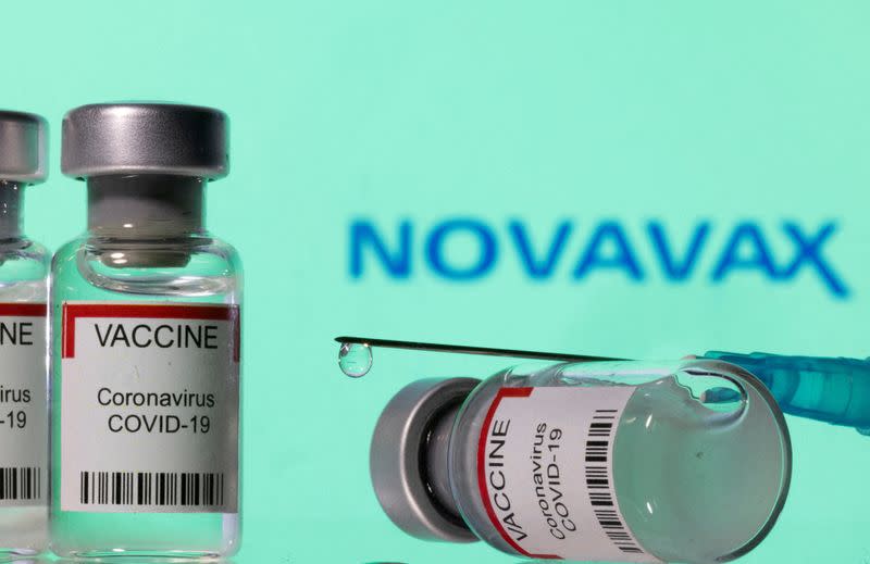 FILE PHOTO: Illustration shows vials labelled "VACCINE Coronavirus COVID-19" and a syringe in front of a displayed Novavax logo