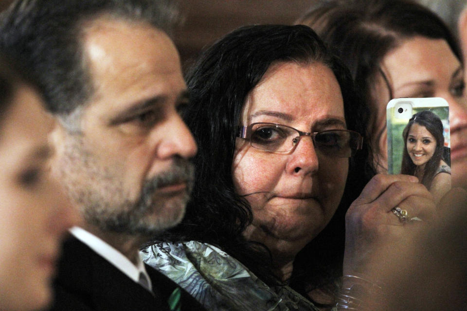 Donna Soto, mother of slain Sandy Hook Elementary School teacher Victoria Soto, holds a cell phone with her daughter's picture on it while attending a ceremony in the East Room of the White House in Washington, Friday, Feb. 15, 2013, where President Barack Obama presented the 2012 Citizens Medal Soto and others. (AP Photo/Jacquelyn Martin)