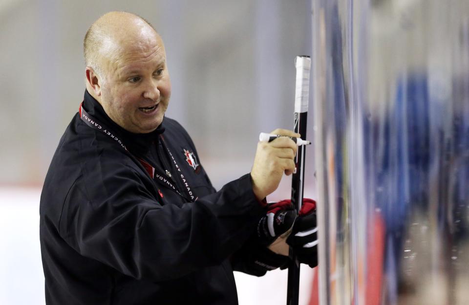 ST CATHARINES, ON - DECEMBER 15: Head Coach Benoit Groulx draws on a white board during the Canada National Junior Team practice at the Meridian Centre on December 15, 2014 in St Catharines, Ontario, Canada. (Photo by Vaughn Ridley/Getty Images)