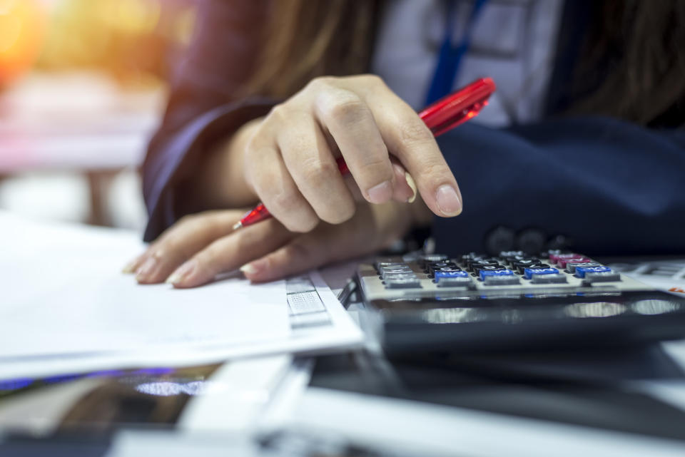 Hands of bank officer calculating loans