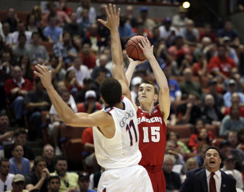 Wisconsin 's Sam Dekker (15) shoots past Arizona's Aaron Gordon (11) during the first half in a regional final NCAA college basketball tournament game, Saturday, March 29, 2014, in Anaheim, Calif. (AP Photo/Jae C. Hong)