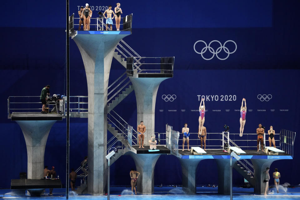 FILE - In this July 21, 2021 file photo, athletes practice during a diving training session at the Tokyo Aquatics Centre at the 2020 Summer Olympics, in Tokyo, Japan. The Tokyo Aquatics Centre is a site to behold -- a towering, 15,000-seat venue that will host swimming and diving at the pandemic-delayed Summer Games. (AP Photo/Matthias Schrader,File)