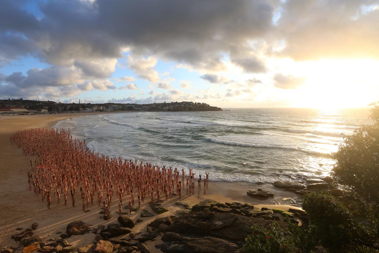 Members of the public pose at sunrise for photographic artist Spencer Tunick at Bondi Beach on November 26, 2022 in Sydney, Australia. US artist and photographer Spencer Tunick created the nude installation using thousands of volunteers posing at sunrise on Bondi Beach, commissioned by charity Skin Check Champions to raise awareness of skin cancer and to coincide with National Skin Cancer Action Week.