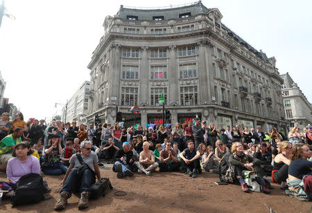 Climate change activists sit at Oxford Circus during the Extinction Rebellion protest in London, Britain April 18, 2019. REUTERS/Simon Dawson